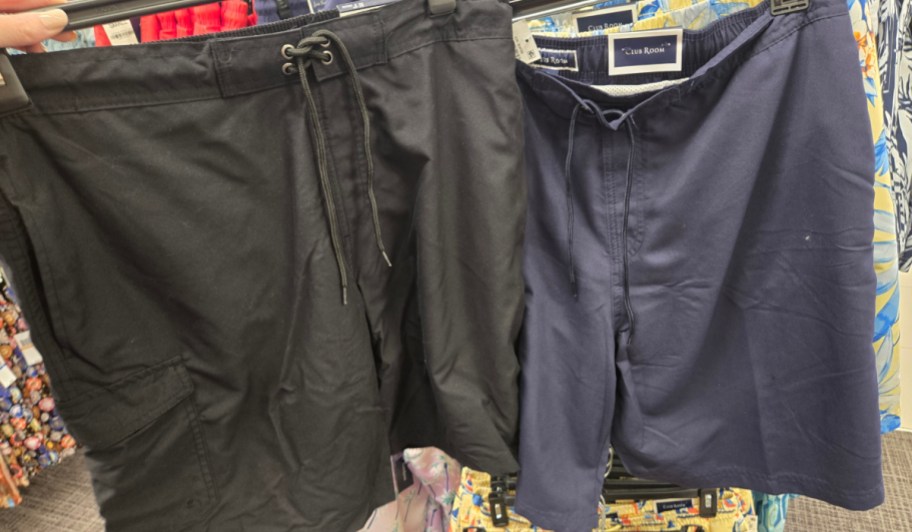 black and navy board shorts in store on hangers