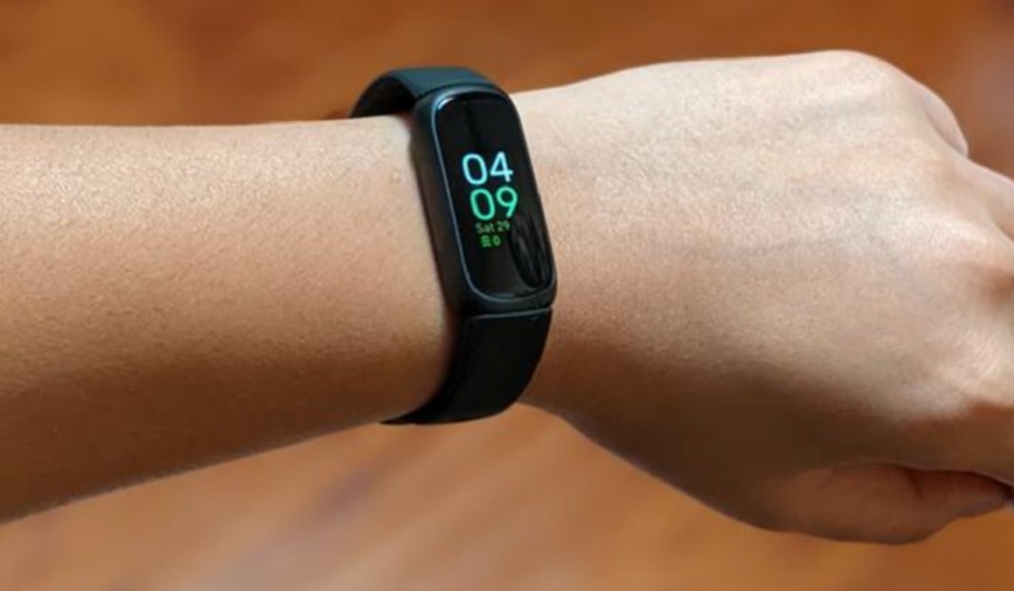 slim black fitbit on wrist