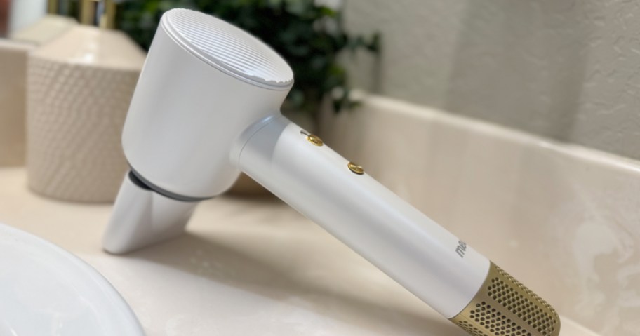 white ionic hair dryer laying on bathroom counter