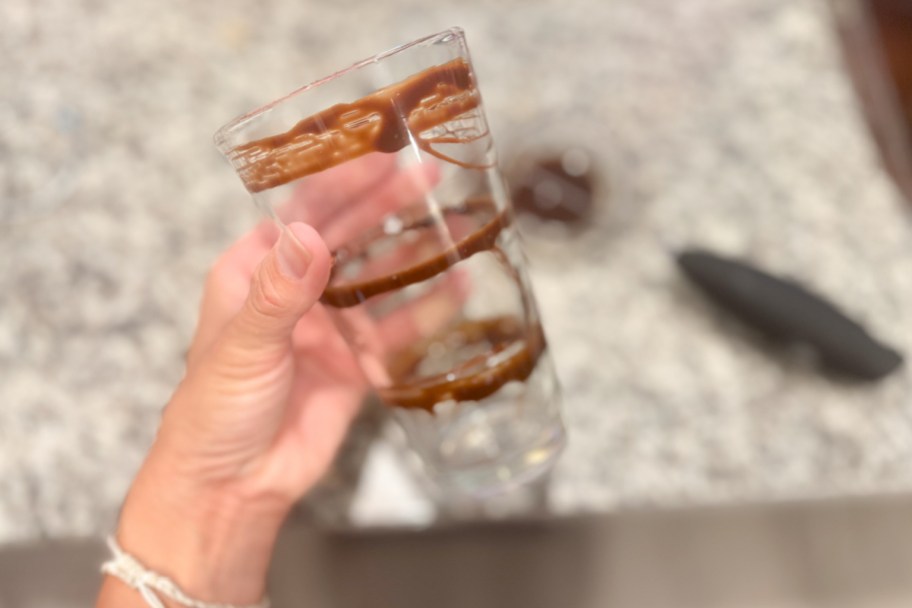 hand holding glass with rings of chocolate