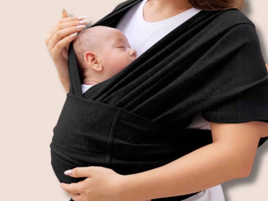 woman with a baby in a black baby wrap carrier