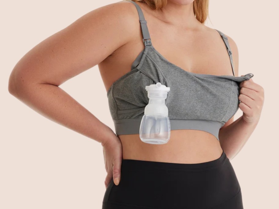 woman wearing a grey nursing bra with a pump on one side