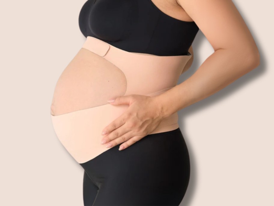 a pregnant woman wearing a belly support wrap