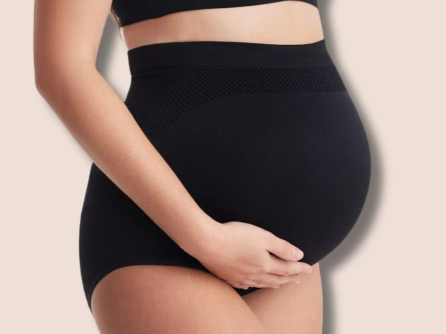 a pregnant woman wearing a black pregnancy belly support panty