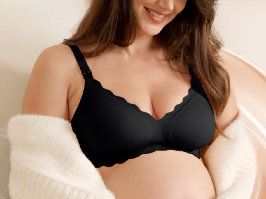woman sitting in a chair wearing a black nursing bra