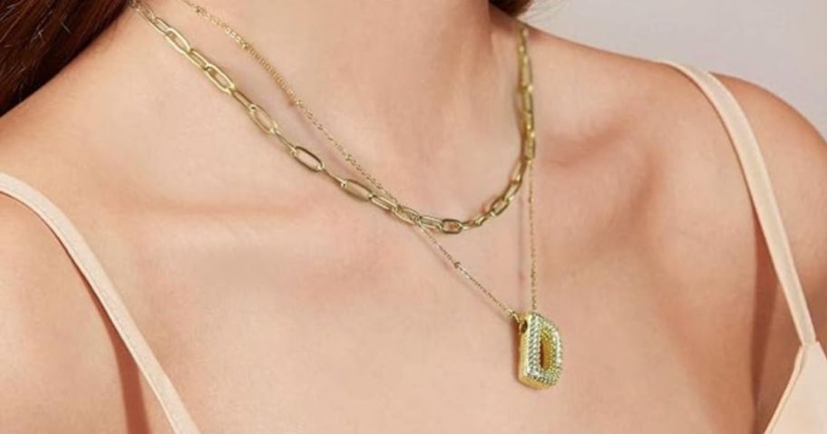 woman wearing initial necklace