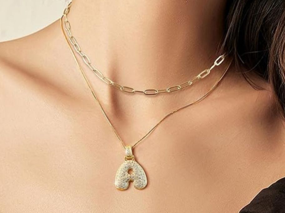 woman wearing initial necklace