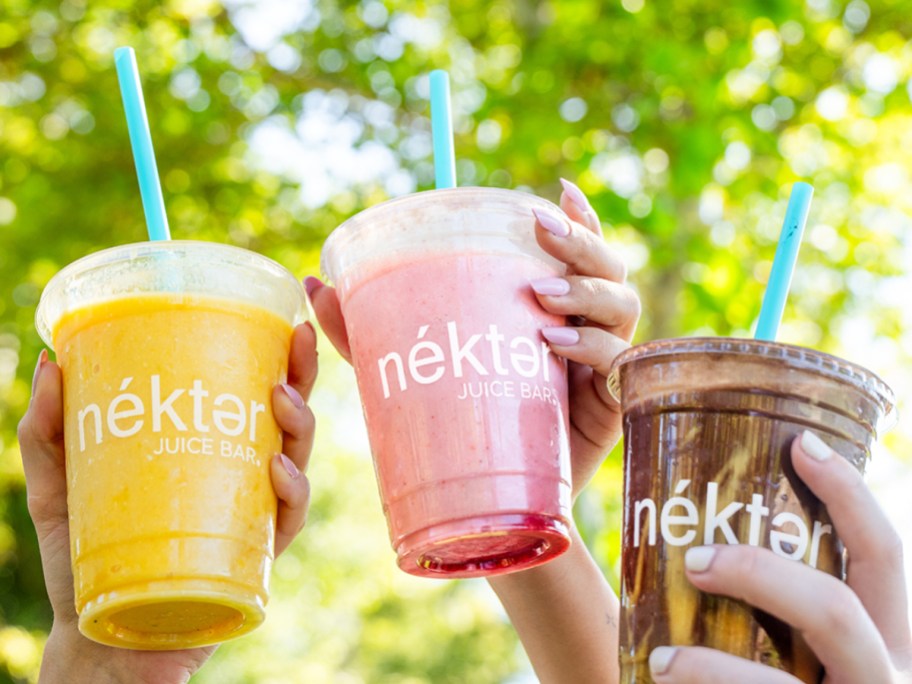 holding 3 smoothies