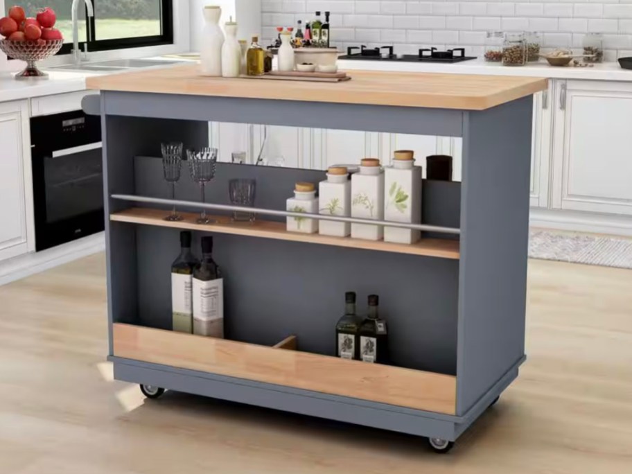 navy blue and wood kitchen island with food on shelves 