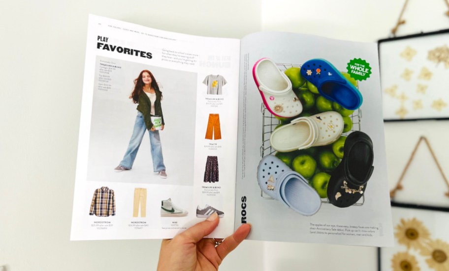 hand holding a nordstrom anniversary sale magazine with kids deals