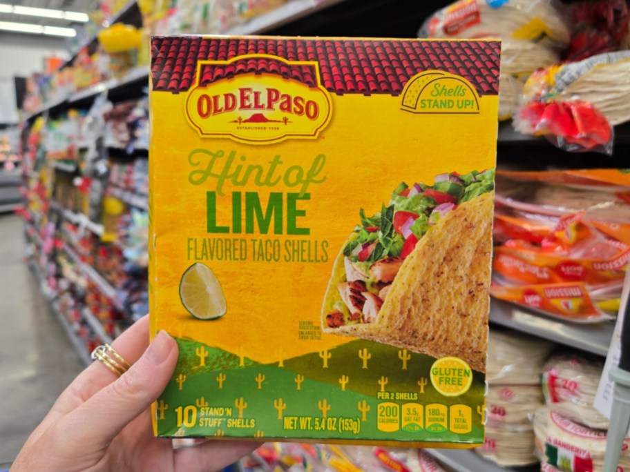 hand holding a box of Old El Paso Stand ‘N Stuff Crunchy Taco Shells, Hint of Lime Flavored