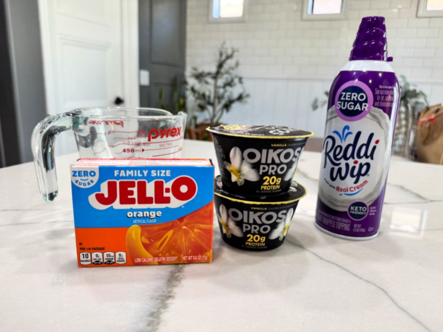 orange sugar-free jello and vanilla greek yogurt on the counter (