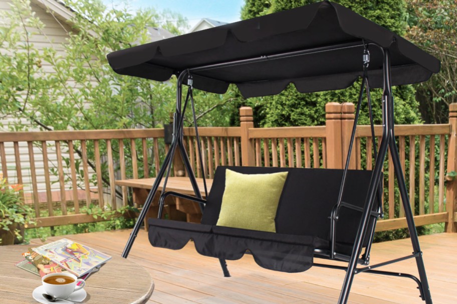 black patio swing on a deck