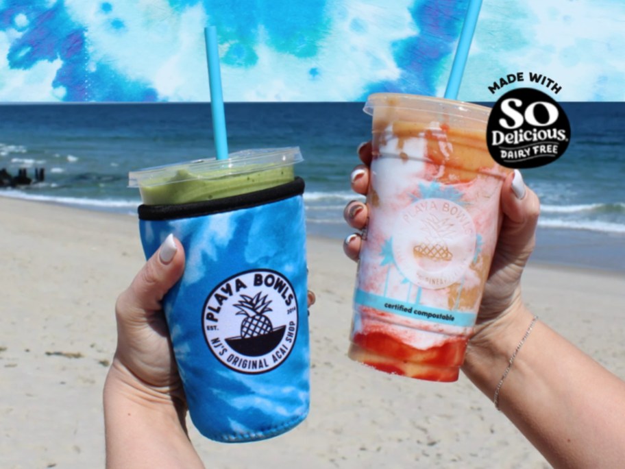 holding 2 smoothies on the beach