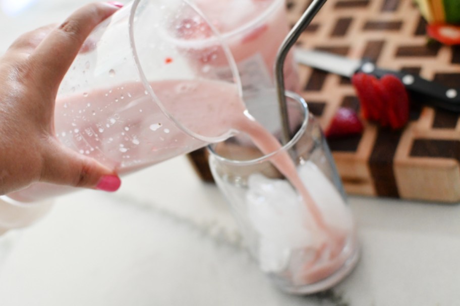 pouring beverage from a blender to a cup