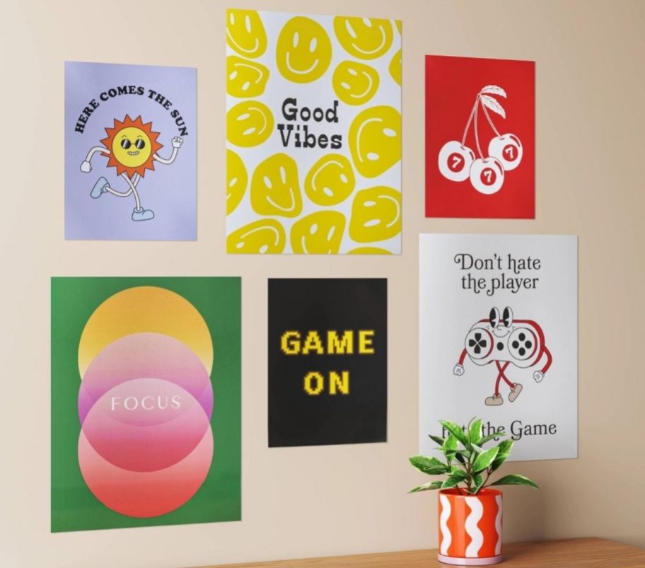 6 graphic posters in various sizes arranged on a wall