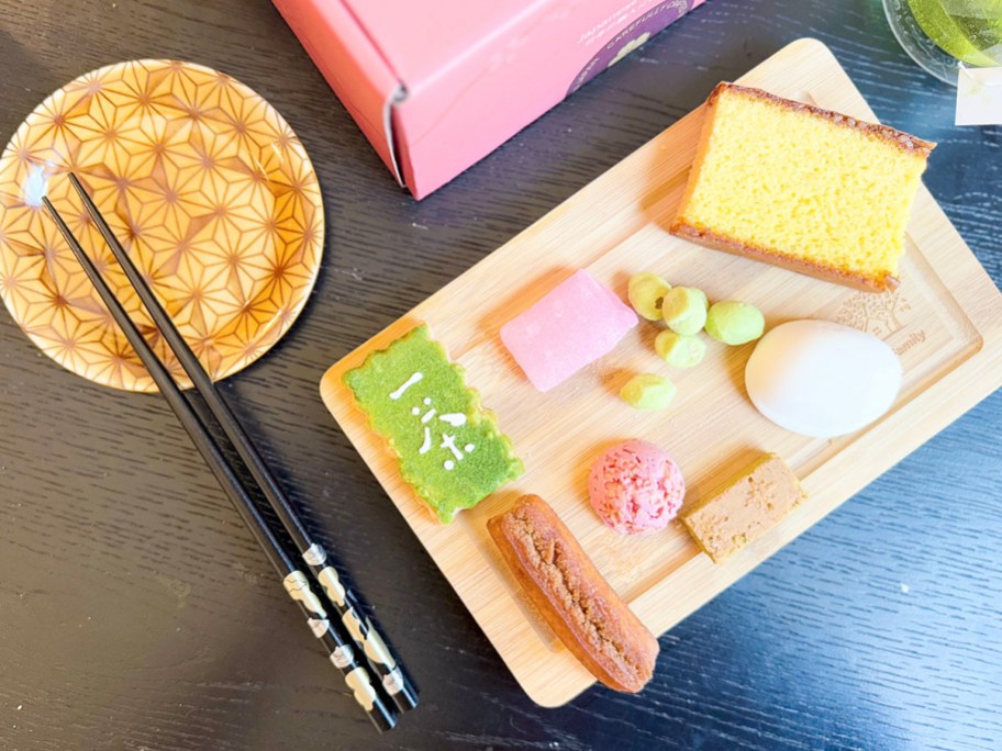 japanese treats on cutting board with chopsticks