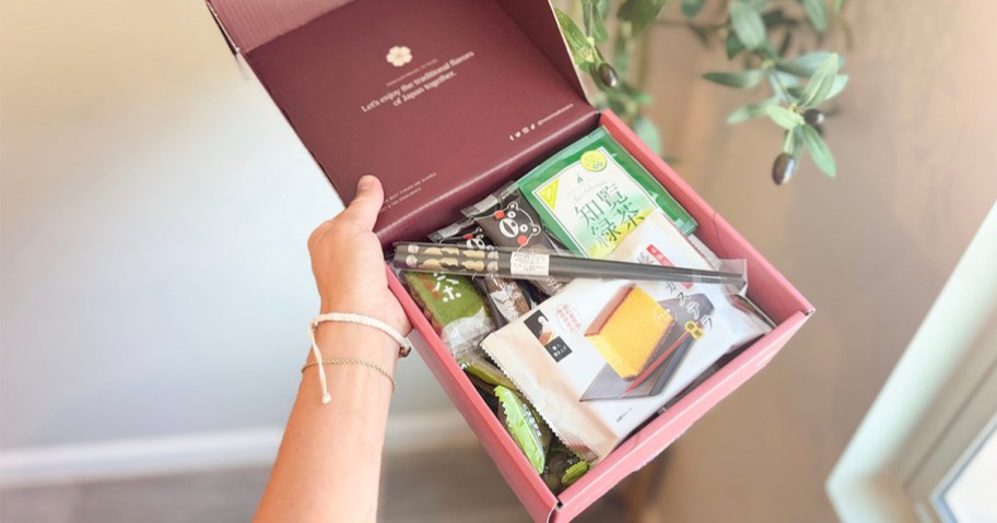 hand holding sakura box full of treats 