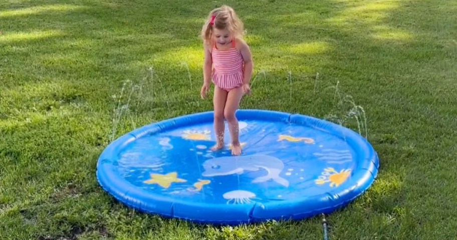 child playing on splash pad