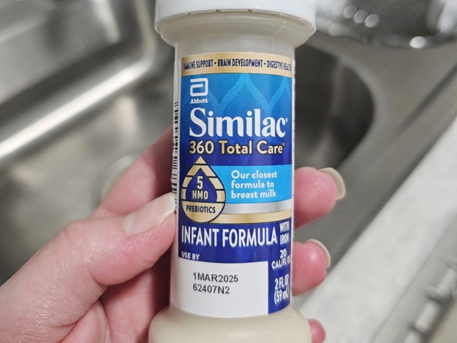 hand holding bottle of similac bottle 