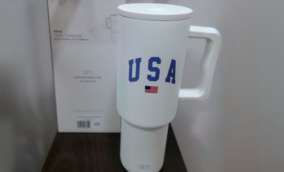 a white USA tumbler with lid and straw