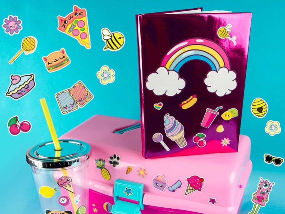 Lunch box and diary filled with fun stickers displayed on them 