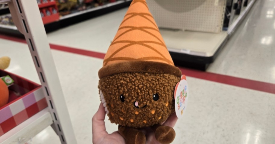 hand holding a chocolate cupcake plush