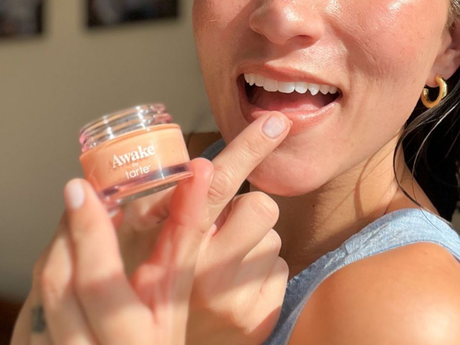 Woman applying a tarte maracuja lip mask