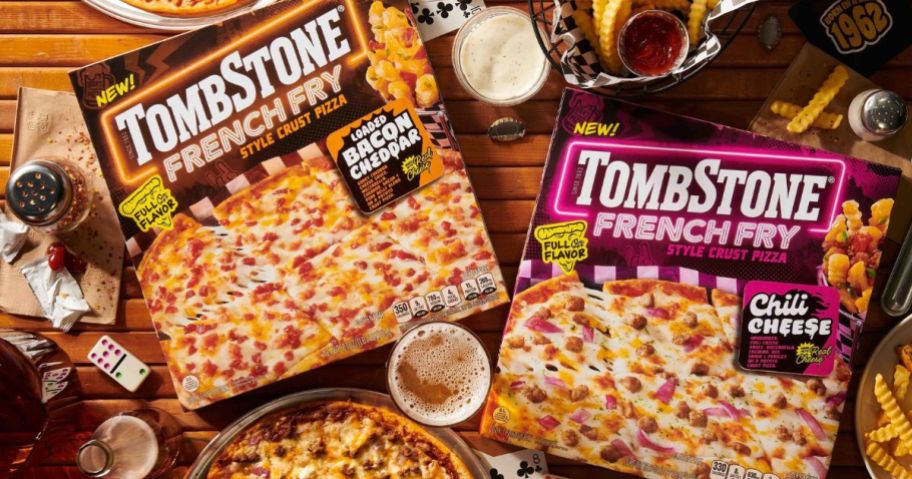 two tombstone fresh fry crust pizza boxes on tables with drinks and pizza around them