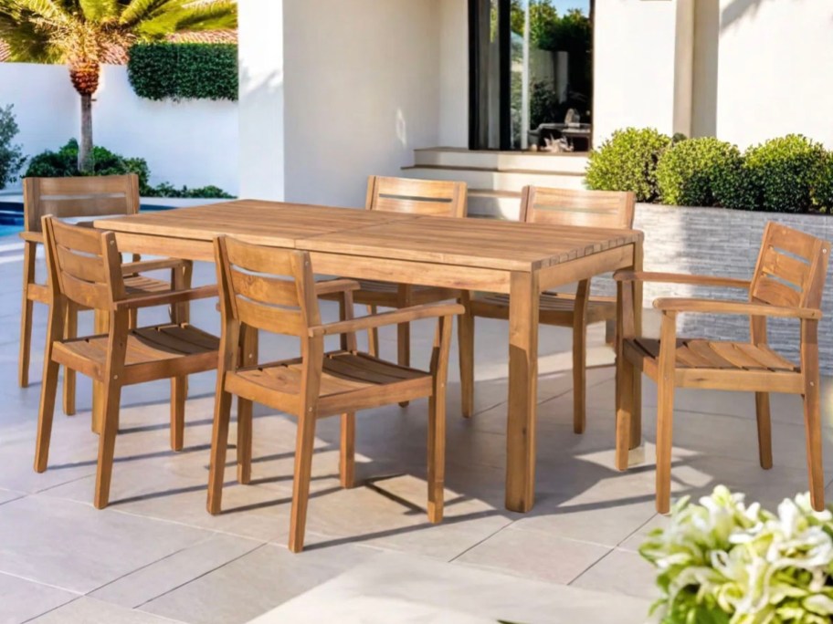 teak dining table and 6 chairs on patio 