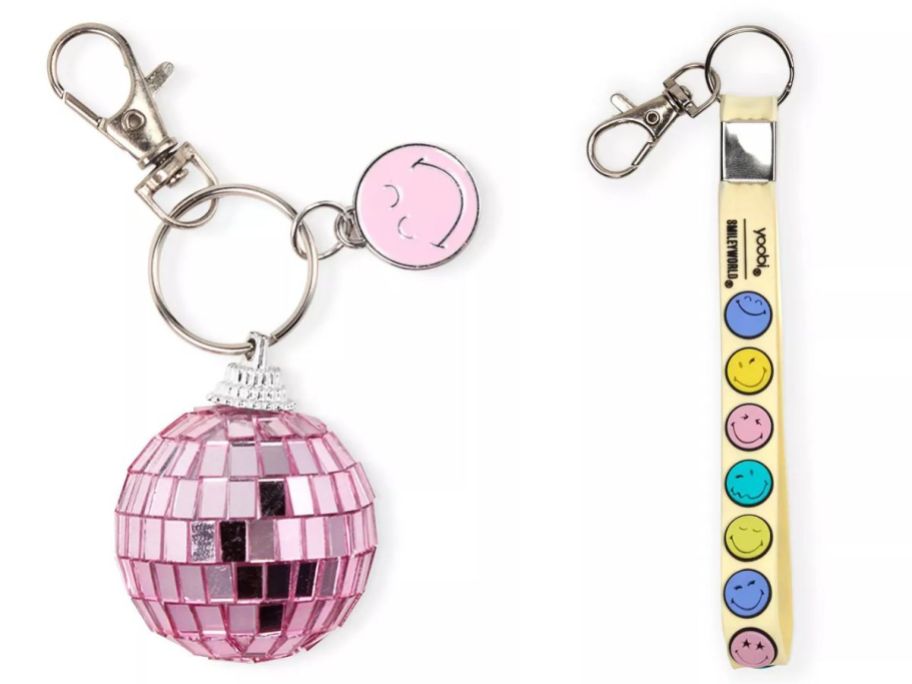 a Yoobi SmileyWorld pink disco ball keychain and a wristlet keychain